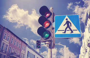 Wall Mural - Retro filtered photo of traffic lights and pedestrian crossing sign, Szczecin, Poland.