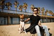 © wayhome.studio  - Strong bearded man in sunglasses sitting in sand with friend dog