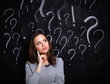 © shefkate - Young girl with question mark on a gray background