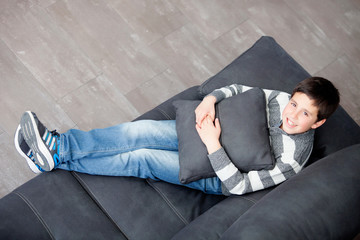 Sticker - Smiling preteen on the sofa at home