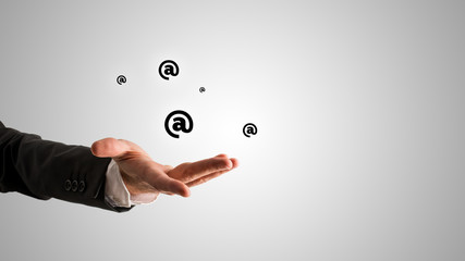 Wall Mural - open businessman hand with @ symbols above