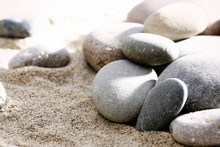 Gray Sea Pebbles On Sand Background