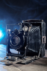 Retro photo Camera on wooden table.