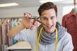 © WavebreakmediaMicro - Smiling student holding pair of scissors