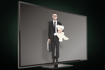 Poster - Composite image of geeky businessman holding briefcase and teddy