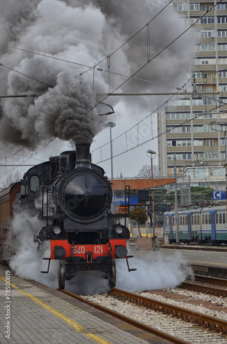 Obraz w ramie Old classic train leaving the station in clouds of smoke