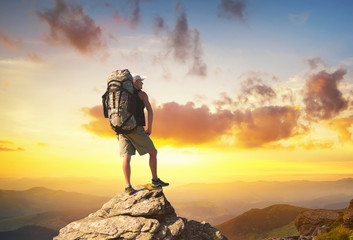 Wall Mural - Tourist on high rocks. Sport and active life concept