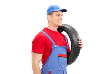 Sticker - Mechanic carrying a tire and walking