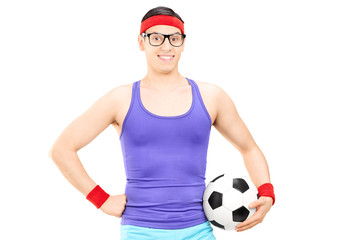 Wall Mural - Nerdy athlete holding a football