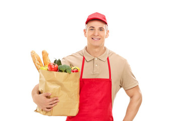 Poster - Young market vendor holding a bag full of groceries