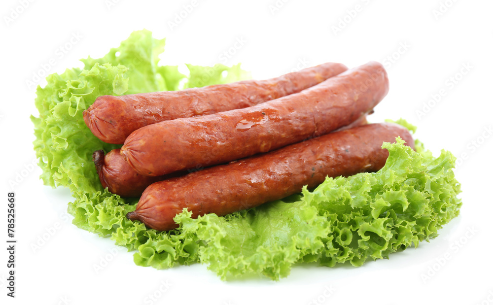 Smoked thin sausages  with lettuce salad leaves, isolated