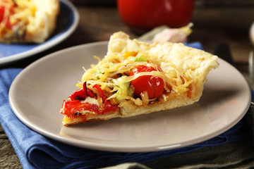 Piece of vegetable pie with paprika, tomatoes and cheese