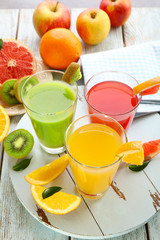 Wall Mural - Fresh juices with fruits on wooden table