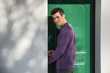 © theartofphoto - Smiling young man entering a door