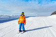 © Sergey Novikov - Small boy wearing ski mask stands on ski-track