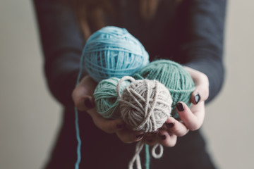 Wall Mural - Hands holding a balls of yarn