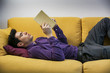 © theartofphoto - Handsome black haired young man reading book at home