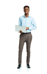 Happy african american college student with laptop standing on w