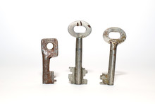 Three Old Keys On A White Background