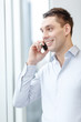 © Syda Productions - smiling businessman with smartphone in office