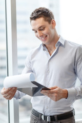 Sticker - smiling businessman with clipboard in office