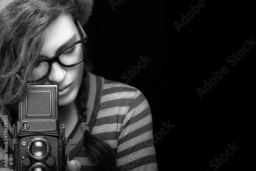 Obraz w ramie Young Woman Capturing Photo Using Vintage Camera. Monochrome Por