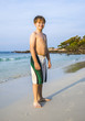 © travelview - happy s  young boy walkes along the beautiful sandy beach
