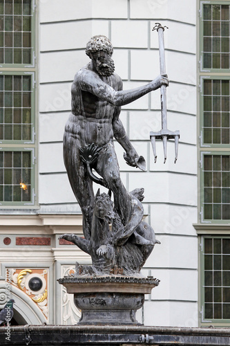 Fototapeta na wymiar Fountain from Neptune statue on old city in gdansk.