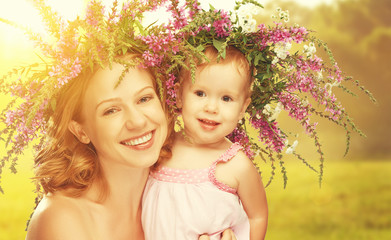 Wall Mural - happy laughing daughter hugging mother in wreaths of summer flow