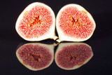 Fototapeta Kuchnia - fruits of sectioned fresh figs isolated on black  background