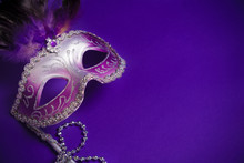 Purple Mardi-Gras Or Venetian Mask On Purple Background