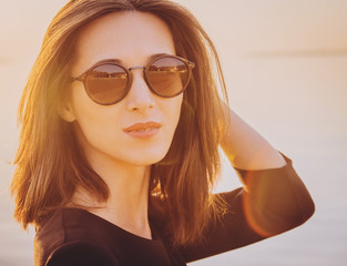 Wall Mural - Beautiful brunette woman in round sunglasses