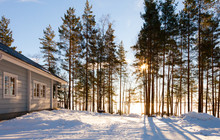 Winter Lake In Forest With House