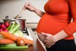 © Martinan - Pregnant woman cooking broccoli