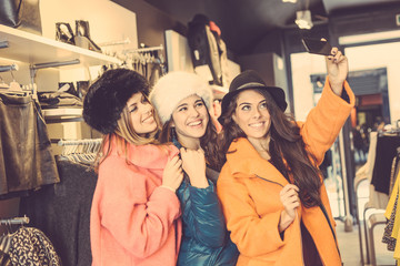 Canvas Print - Three women taking a selfie wearing colorful coats