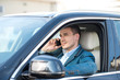© Friends Stock - Young man inside car with phone