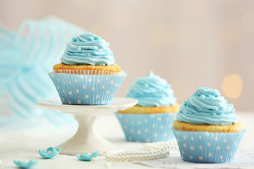 Wall Mural - Delicious cupcakes on table on light background