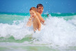 © Olesia Bilkei - happy father and son having fun in waves, summer vacation