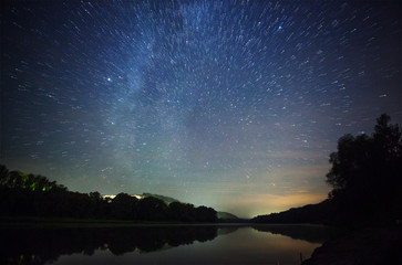 a beautiful night sky, the milky way, star trails and the trees