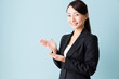 © taka - asian businesswoman on blue background