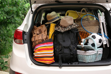 Wall Mural - Suitcases and bags in trunk of car ready to depart for holidays