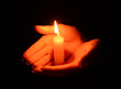 © Africa Studio - Candle in female hands on black background
