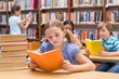 © WavebreakMediaMicro - Cute pupils reading in library
