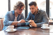 © Stock Rocket - Casual guys in a Cafe looking at mobile phone