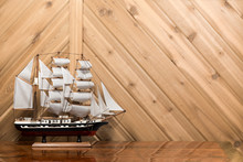 Sailboat / Model Ship Against Plank Wall With Copy Space
