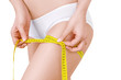 © chettythomas - Slim woman in white underwear  and measure around her leg on