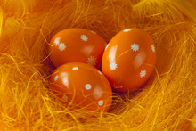 Three Orange Easter Eggs In Nest