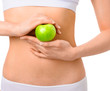 © chettythomas - Slim woman in white underwear with green apple at her hands over