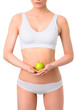 © chettythomas - Slim woman in white underwear with green apple at her hands over