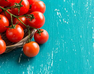 Cherry tomatoes on turquoise background